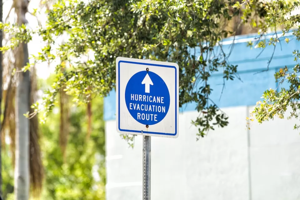 Blue and white "hurricane evacuation route" sign.